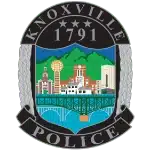Knoxville Police Department badge logo with gold eagle and blue center.