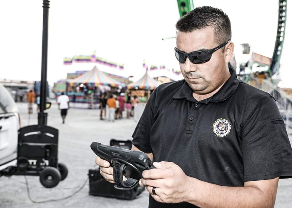Jonesboro Police Department officer operates mobile security system at a carnival using The RATT surveillance tower