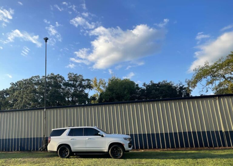 Foley Police Department SUV with raised mobile surveillance tower next to a warehouse