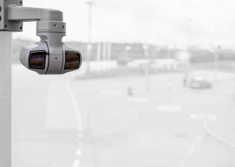 High-resolution PTZ security camera mounted on a pole overlooking a parking lot