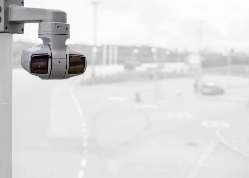 High-resolution PTZ security camera mounted on a pole overlooking a parking lot