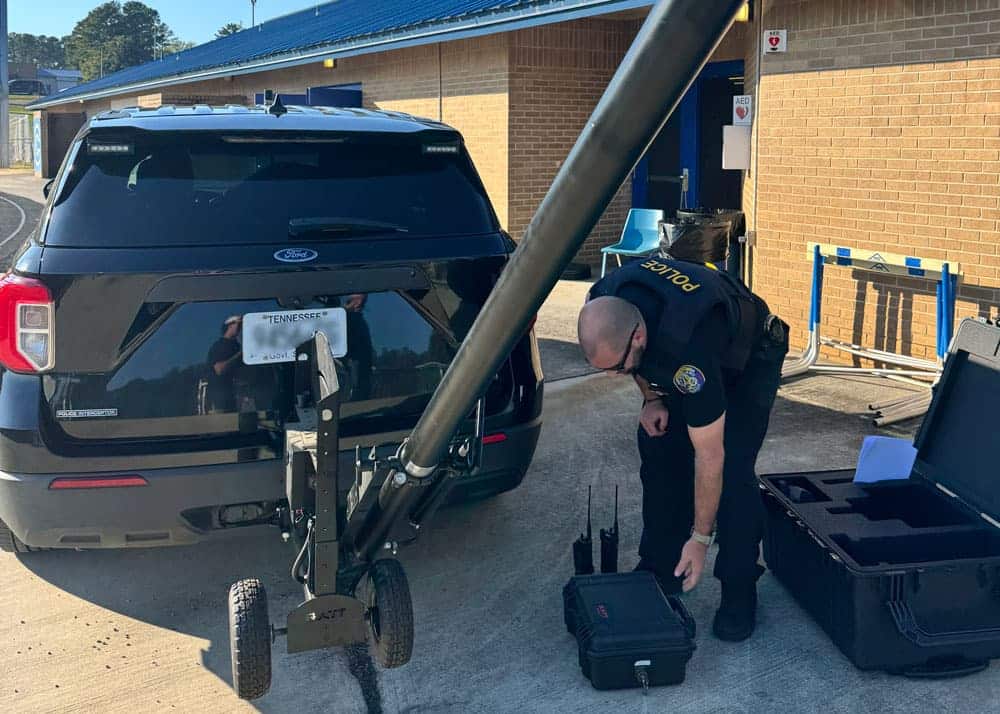 Cleveland Police officer setting up mobile video monitoring system during a high school football game