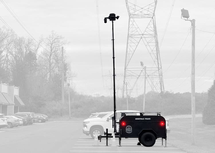 Mobile Surveillance Trailer Providing Aerial Surveillance in Knoxville - Tech Deployments Made Simple by Critical Tech Solutions Mobile surveillance trailer with an elevated camera mast deployed by The Knoxville Police Department in a parking lot