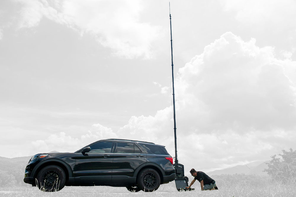 Vehicle hitch-mounted telescopic mast with P25 control station antenna deployed at 26 feet