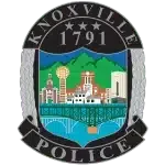 Knoxville Police Department badge logo with gold eagle and blue center.