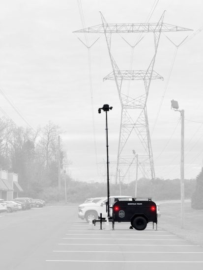 Mobile surveillance trailer with an elevated camera mast deployed by The Knoxville Police Department in a parking lot
