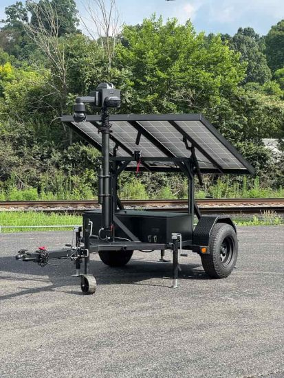 Mobile surveillance trailer with telescopic mast and solar panel system